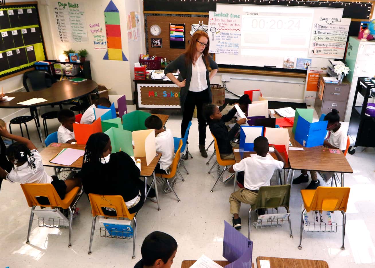 Katie Sokol gives her third-grade class a reading test about over context clues at George...