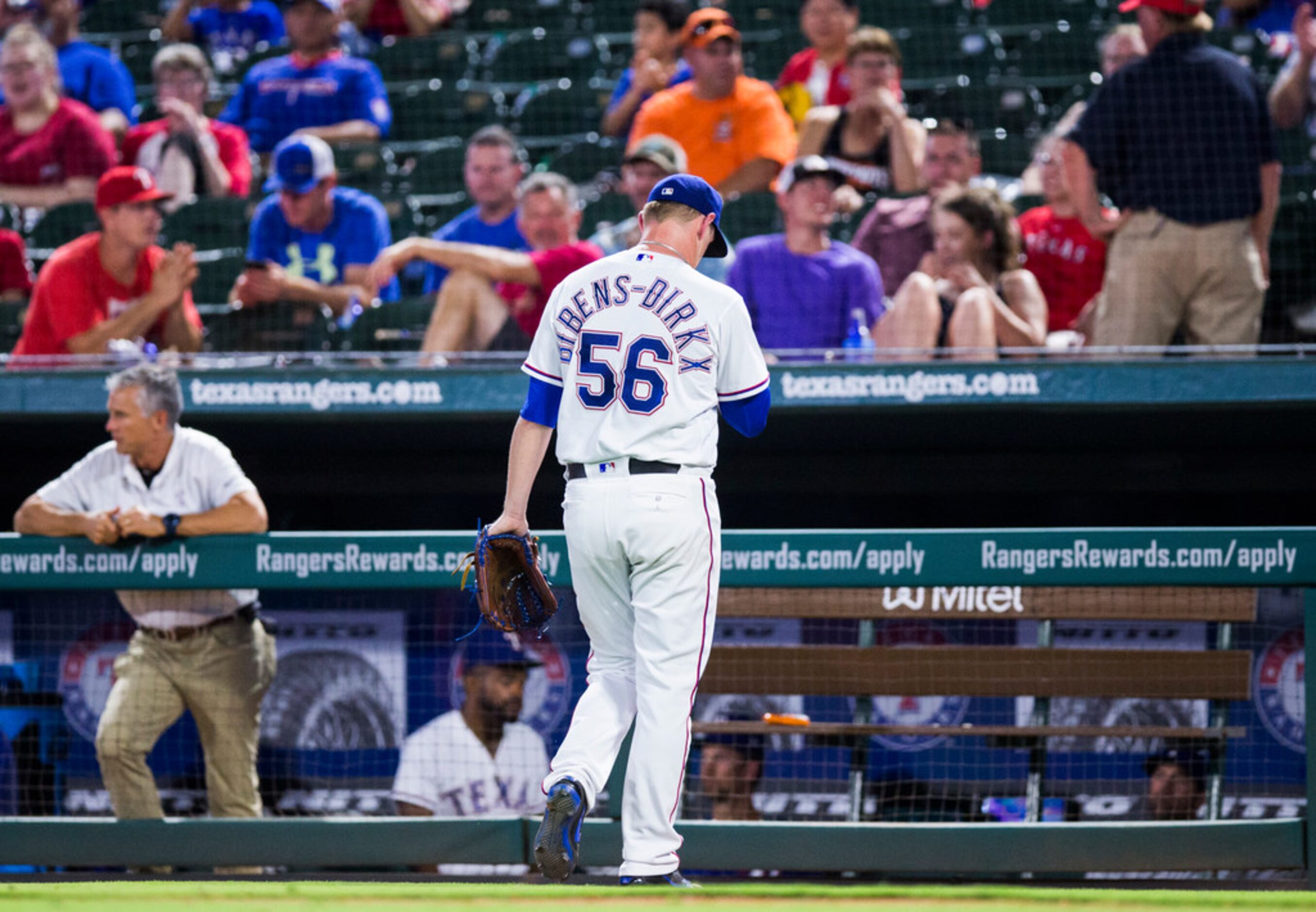 Texas Rangers relief pitcher Austin Bibens-Drikx (56) walks back to the dugout after being...