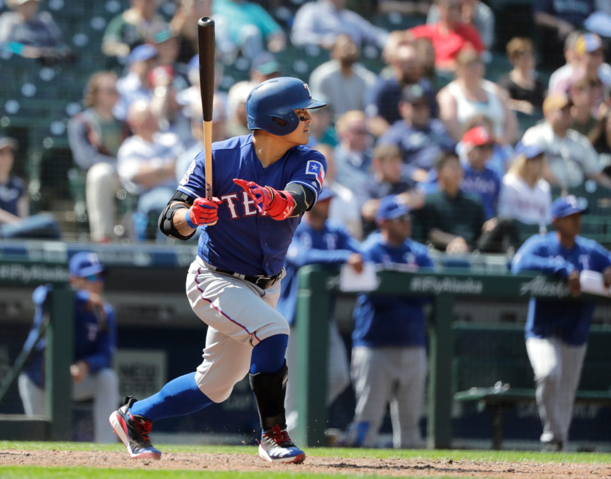 Texas Rangers' Shin-Soo Choo, watches his two-run single that scored Rougned Odor and Nomar...