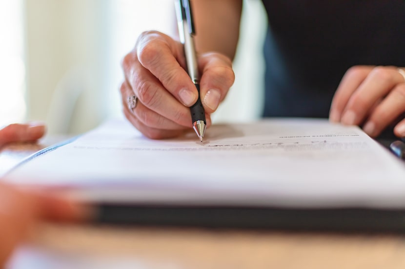 Woman signing paperwork