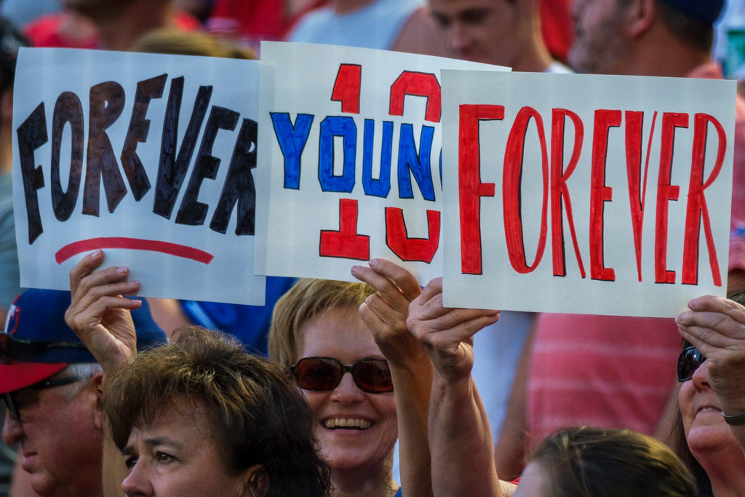 Fans cheer during ceremonies to retire Michael Young's No. 10 before a game against the...