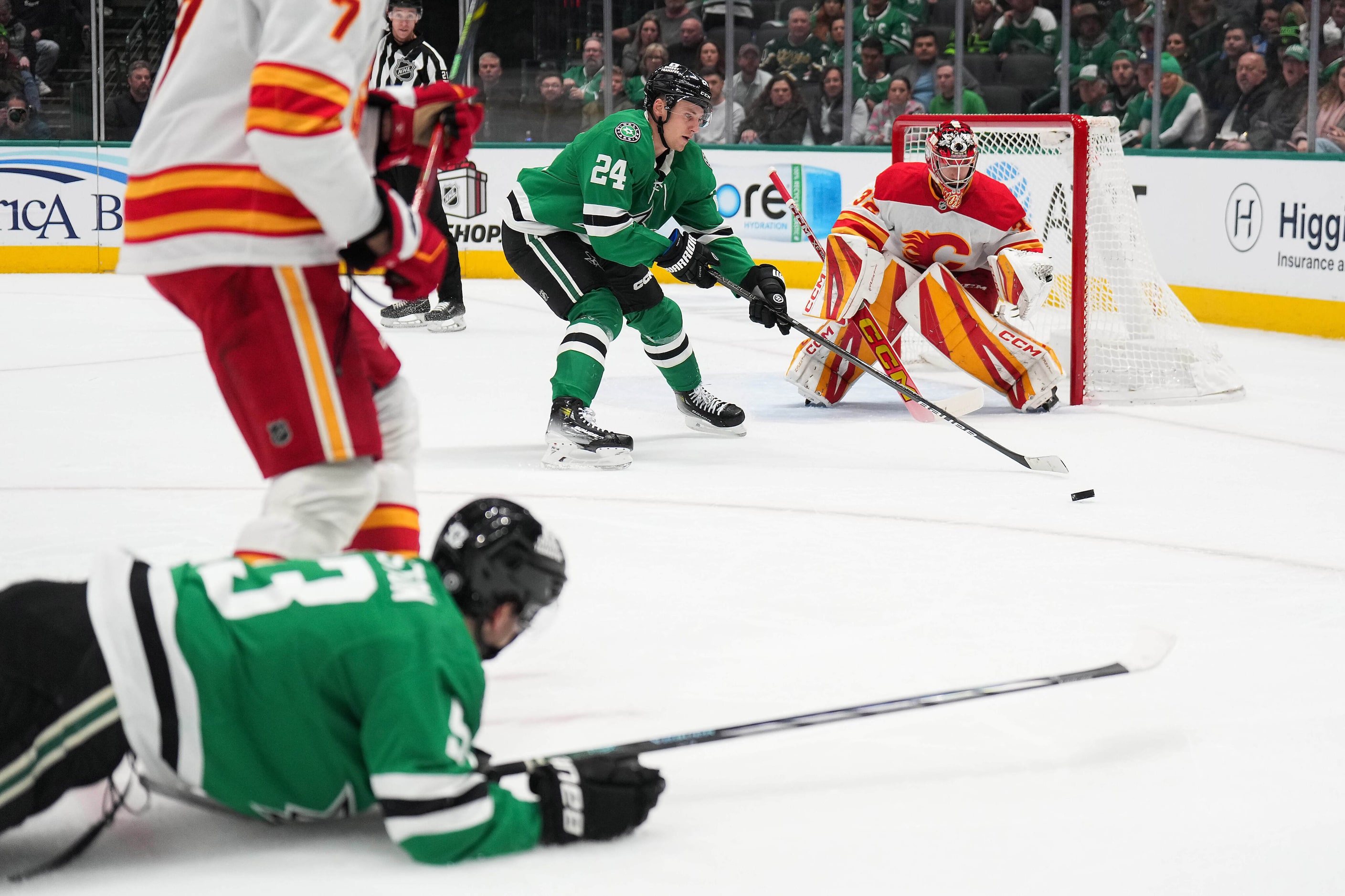 Dallas Stars center Roope Hintz (24) reaches for the puck after center Wyatt Johnston (53)...