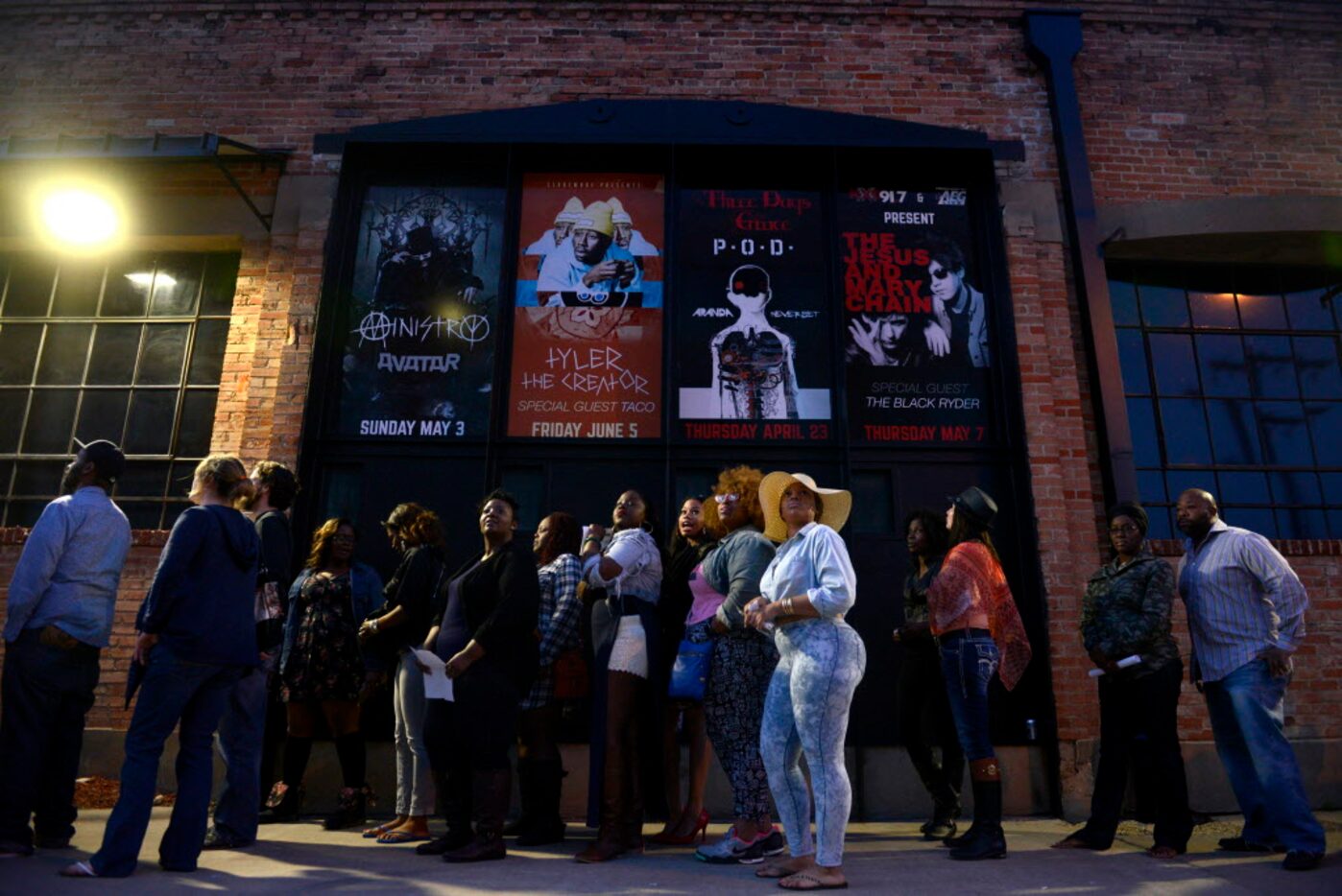 Concert goers line up along the sidewalk in Deep Ellum to see Sarah Jaffe and Erykah Badu...