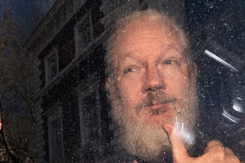Julian Assange gestures as he arrives at Westminster Magistrates' Court in London, after the...