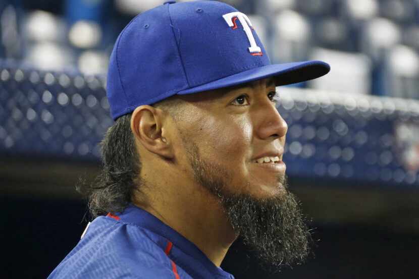 Texas Rangers starting pitcher Yovani Gallardo (49) is pictured as he talks with the media...