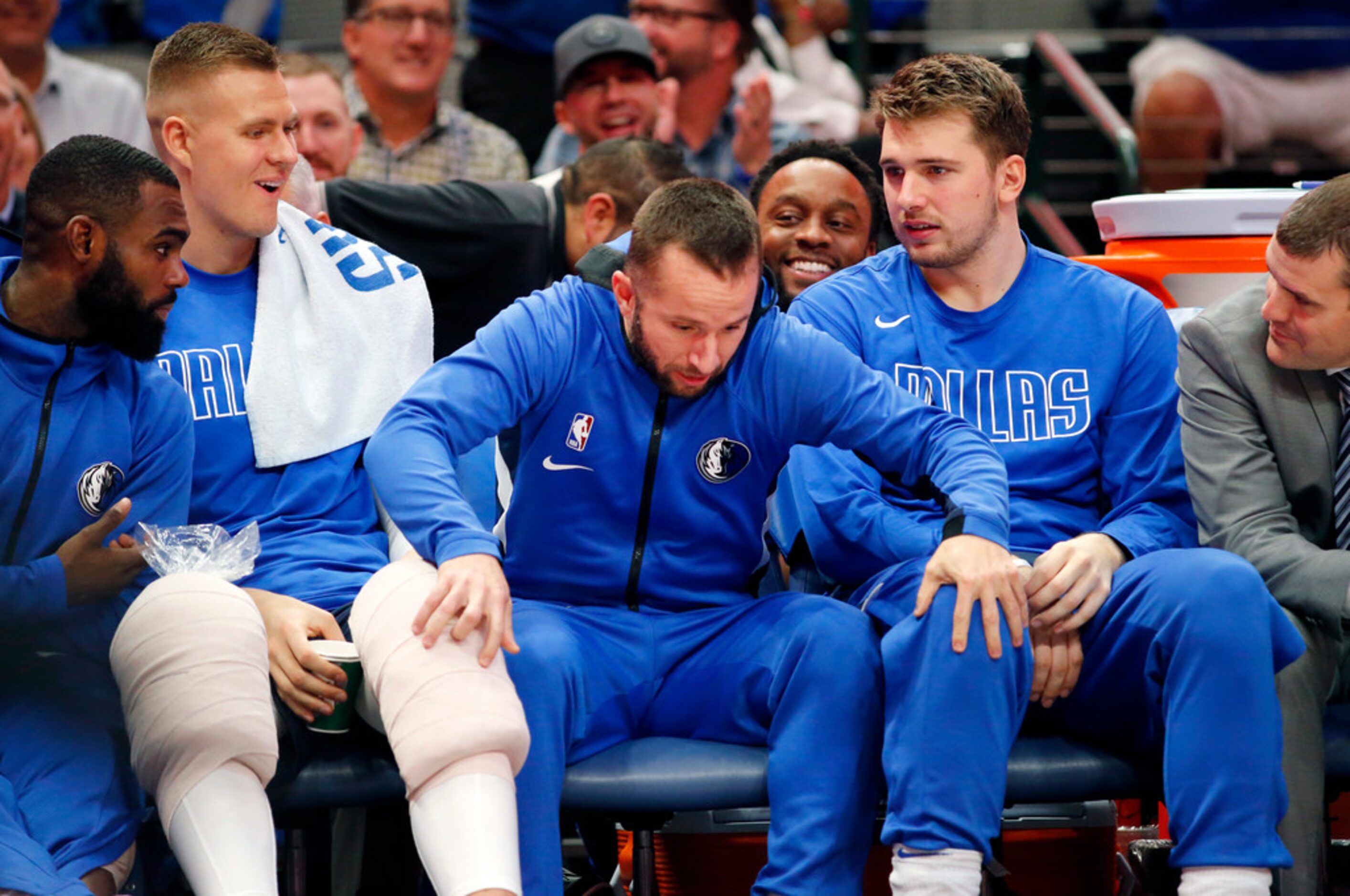 After a continuous chant of J-J, Dallas Mavericks guard J.J. Barea (center) leaps off the...