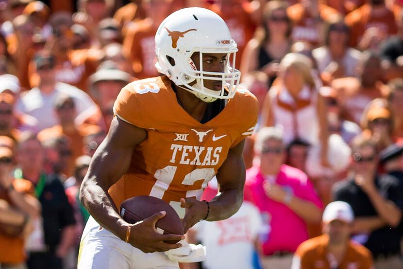 Texas quarterback Jerrod Heard (13) runs with the ball during the second half of the 2015...