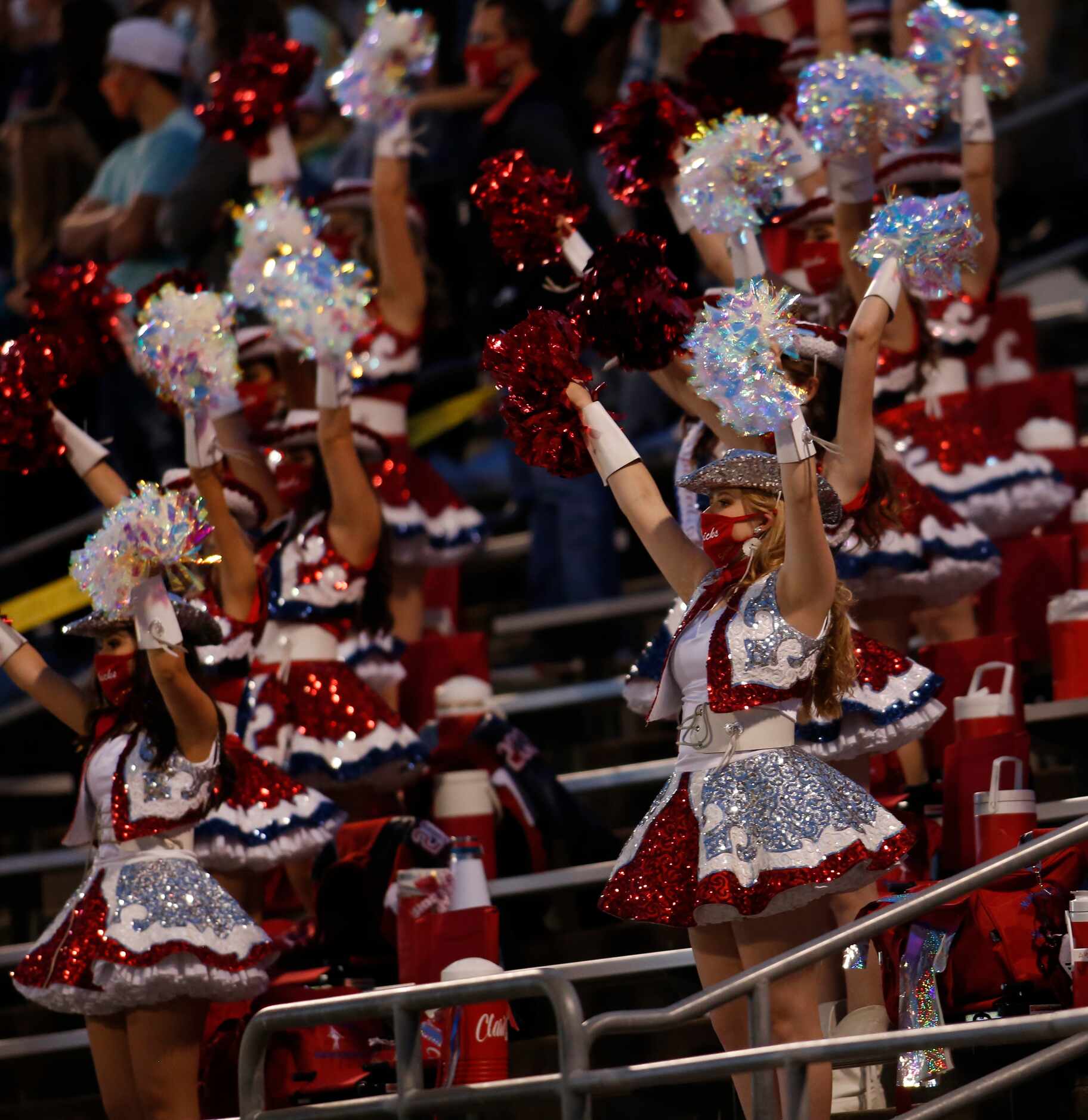 Members of the Northwest drill team show their support from the stands during the first...
