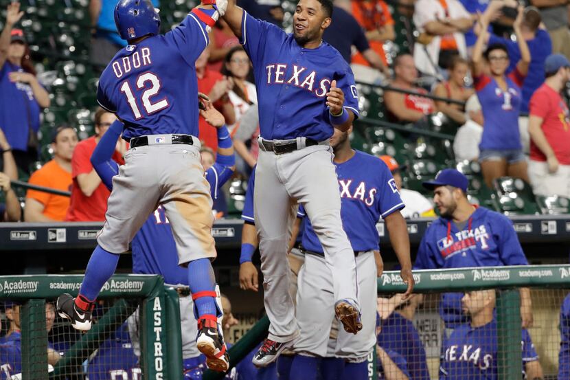 Texas Rangers' Rougned Odor (12) celebrates with Elvis Andrus, right, after hitting a home...