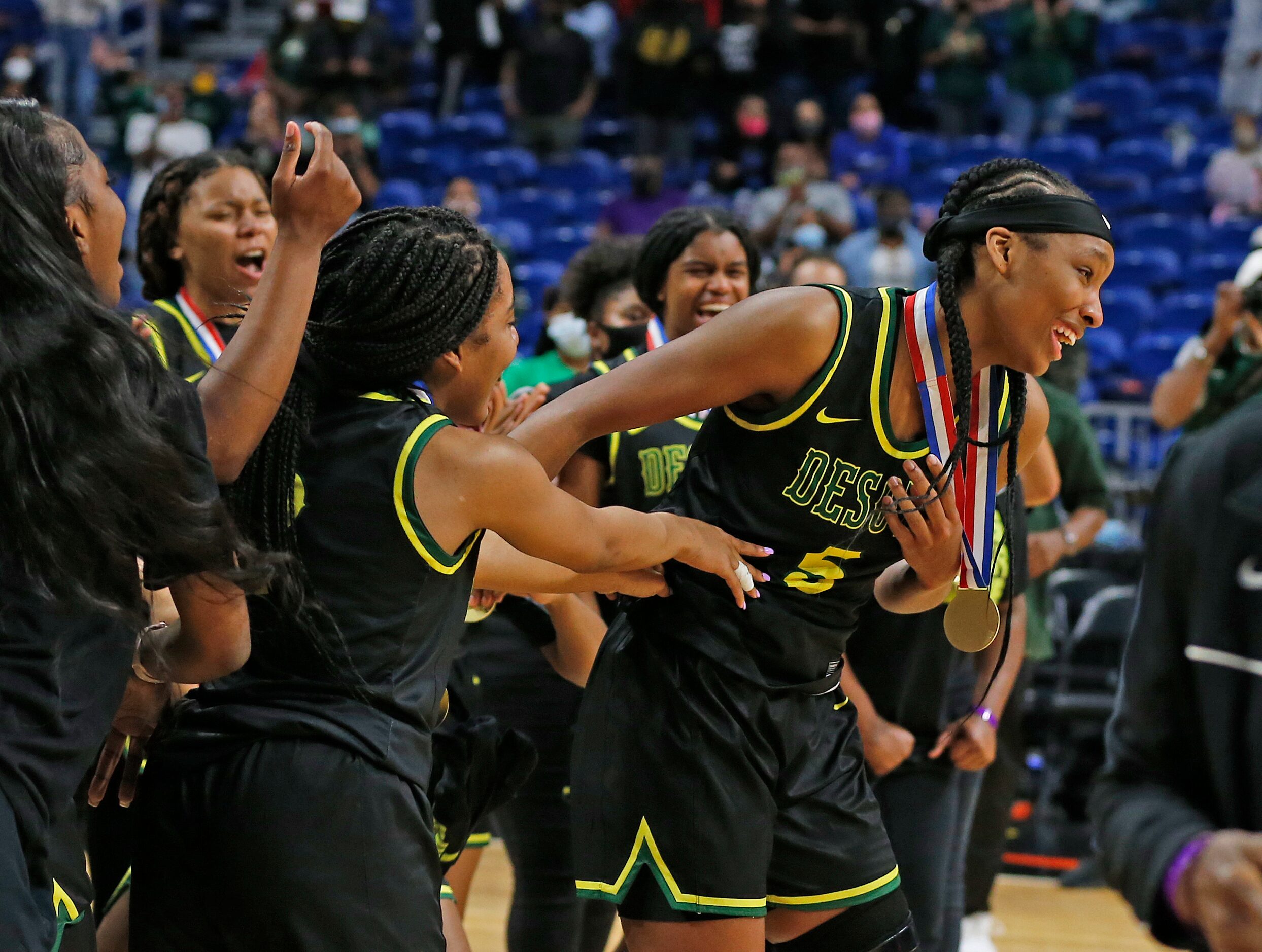 DeSoto Sa’Myah Smith #5 is congratulated by teammates after winning most valuable player....