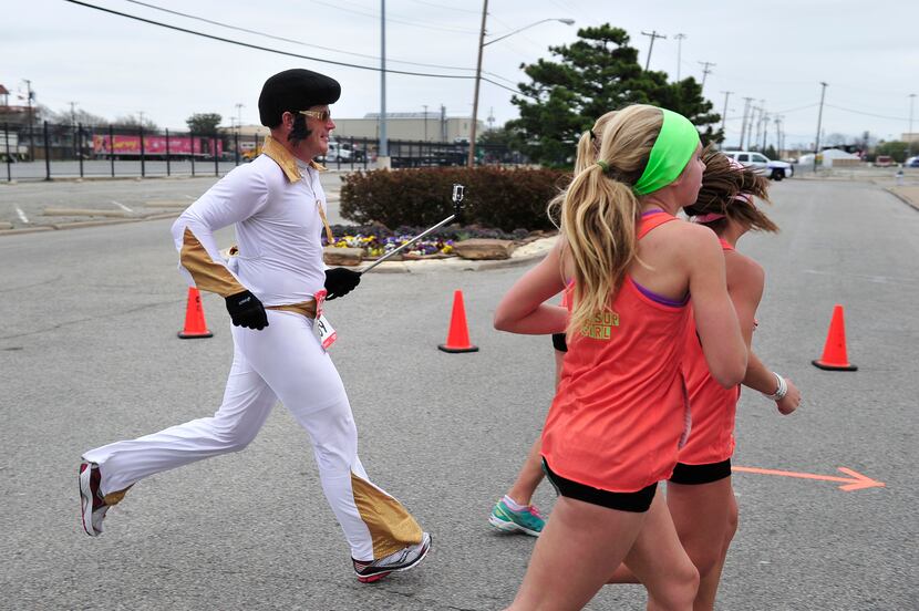 A runner dressed as Elvis runs with his GoPro during the Dallas Rock N' Roll half-marathon...