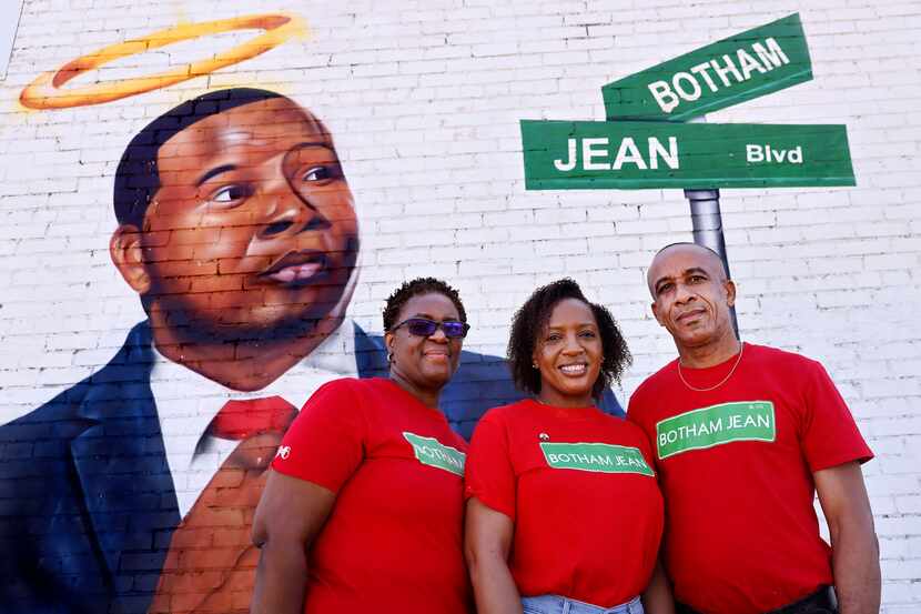 Allison Jean, her daughter, Alissa Findley, and husband, Bertram Jean, pose before a mural...