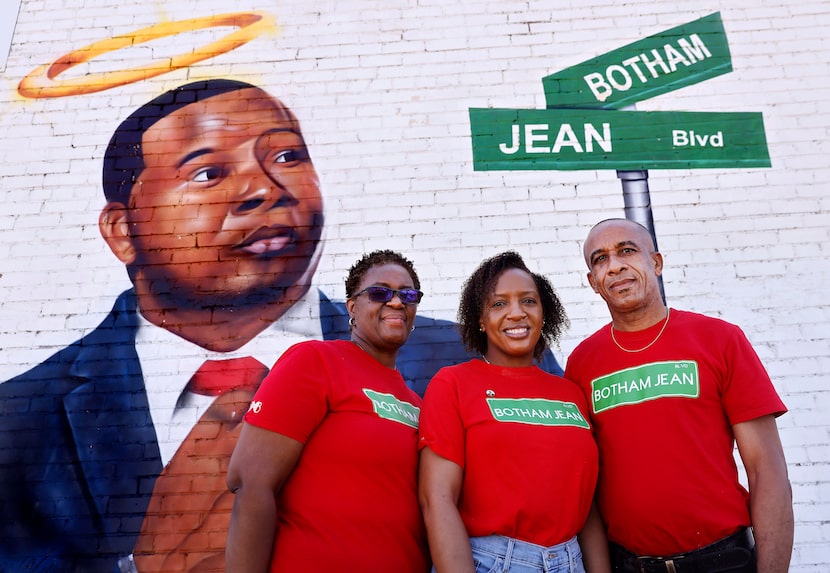 Allison Jean, her daughter, Alissa Findley, and husband, Bertram Jean, pose before a mural...