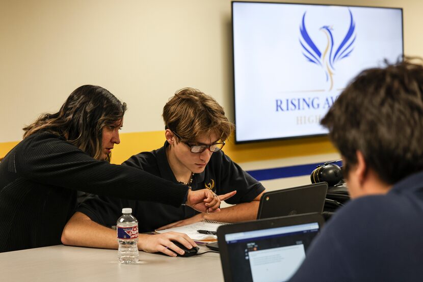 Vice principal Kassandra Dene talks with Jackson Boothe as students work on creating career...