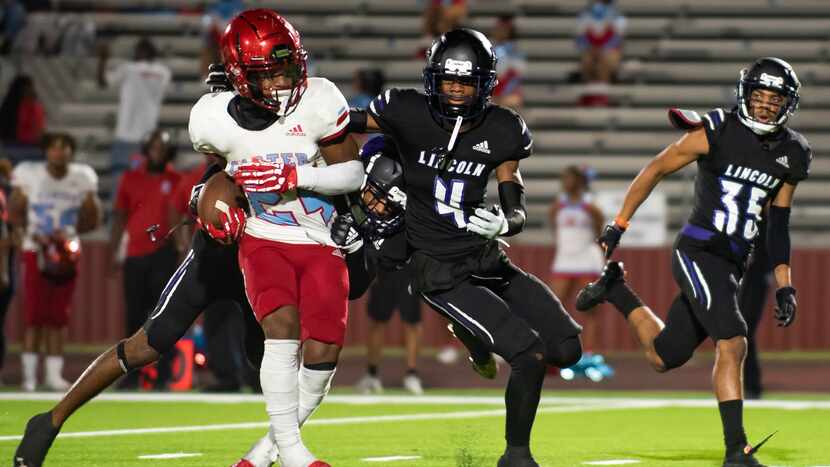 Carter junior Kaeden Landry (24) sheds tackles by Lincoln defenders to rush down the field...