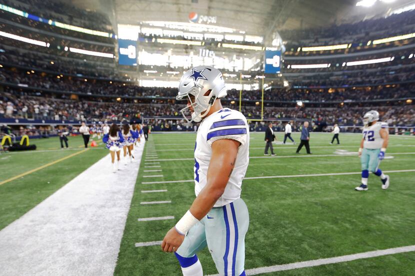 Dallas Cowboys quarterback Dak Prescott (4) walks off the field after losing to the Green...