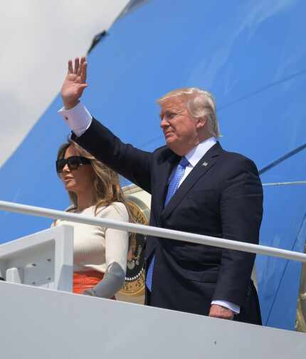 US President Donald Trump and First Lady Melania Trump make their way to board Air Force One...