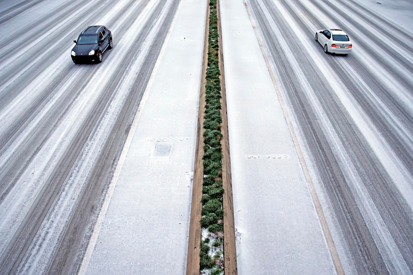 Few cars traveled  along Central Expressway at Caruth Haven Lane during heavy sleet Monday....