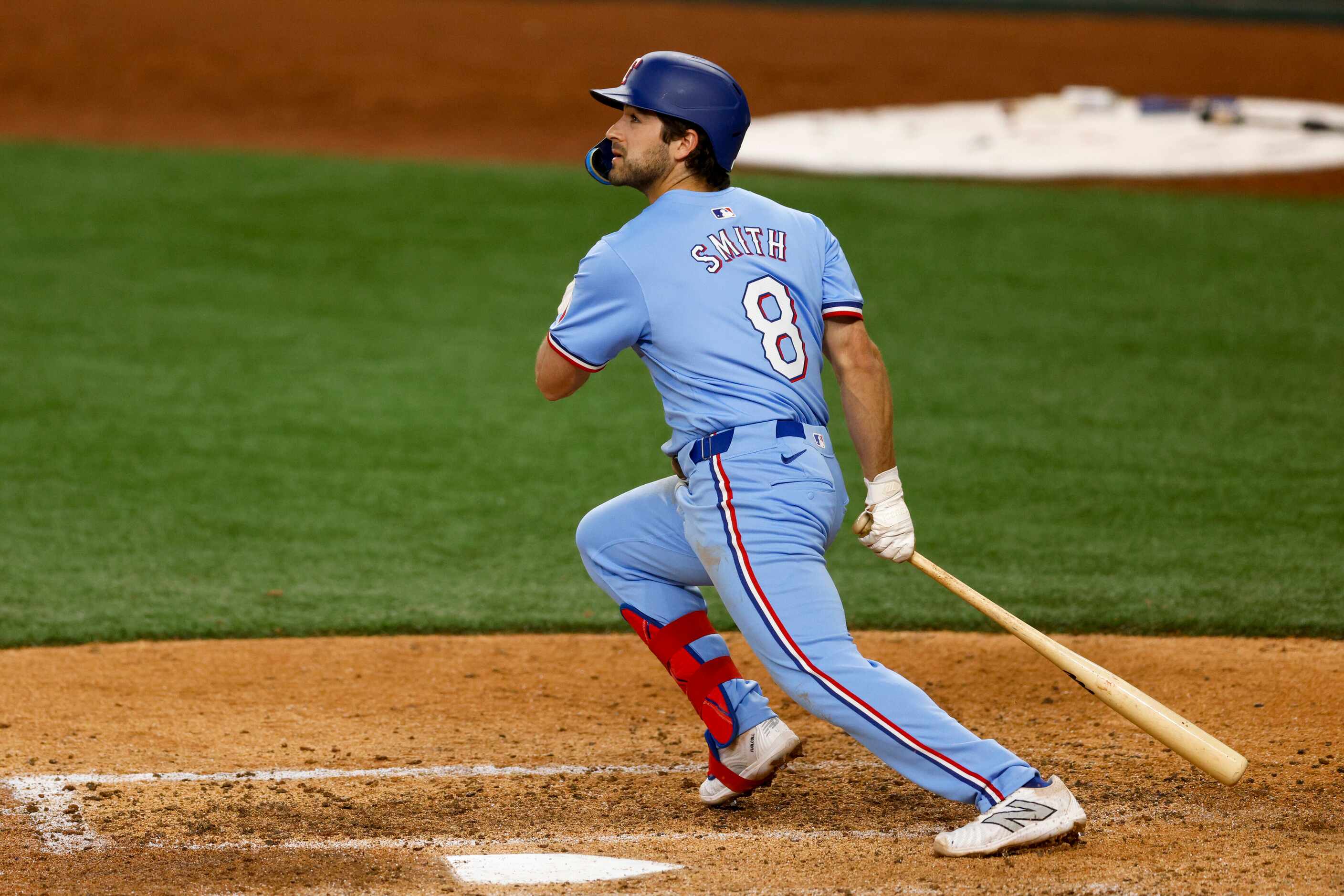 Texas Rangers third baseman Josh Smith (8) watches the ball as he runs to first base during...