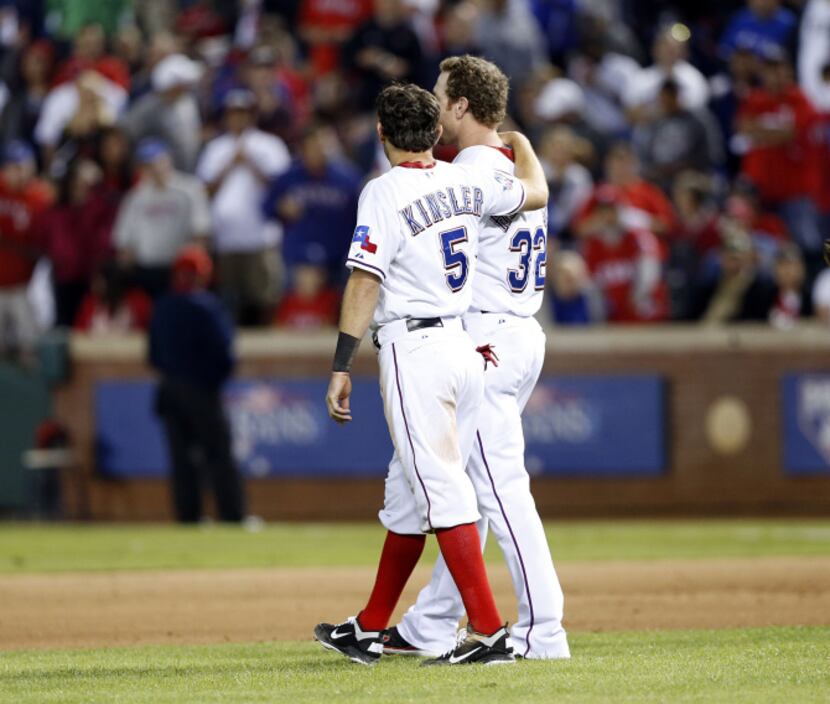 Texas Rangers second baseman Ian Kinsler (5) comforts teammate Josh Hamilton (32) after...