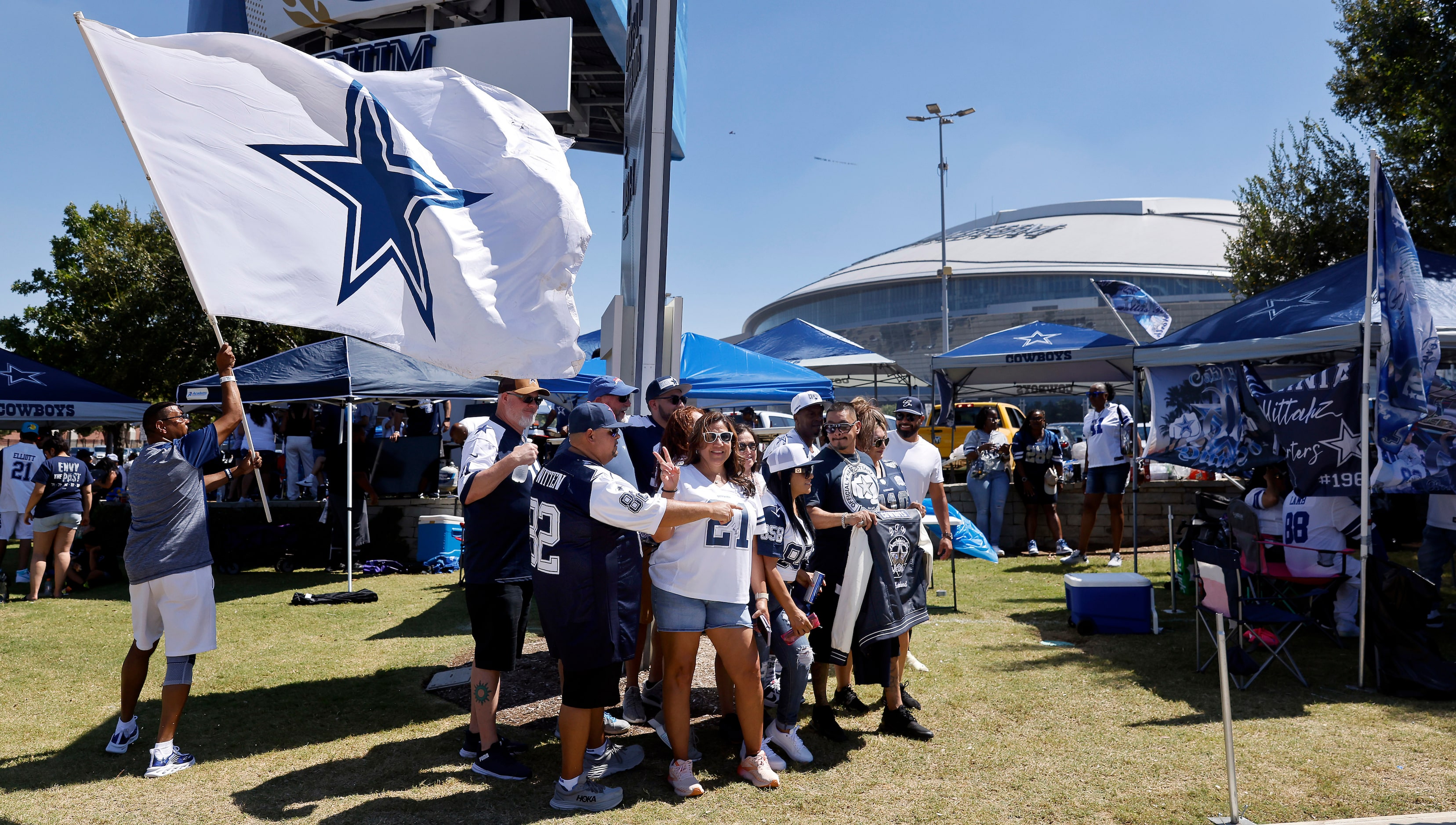 Dallas Cowboys fans gather for a tailgate group photo before their home opener against the...