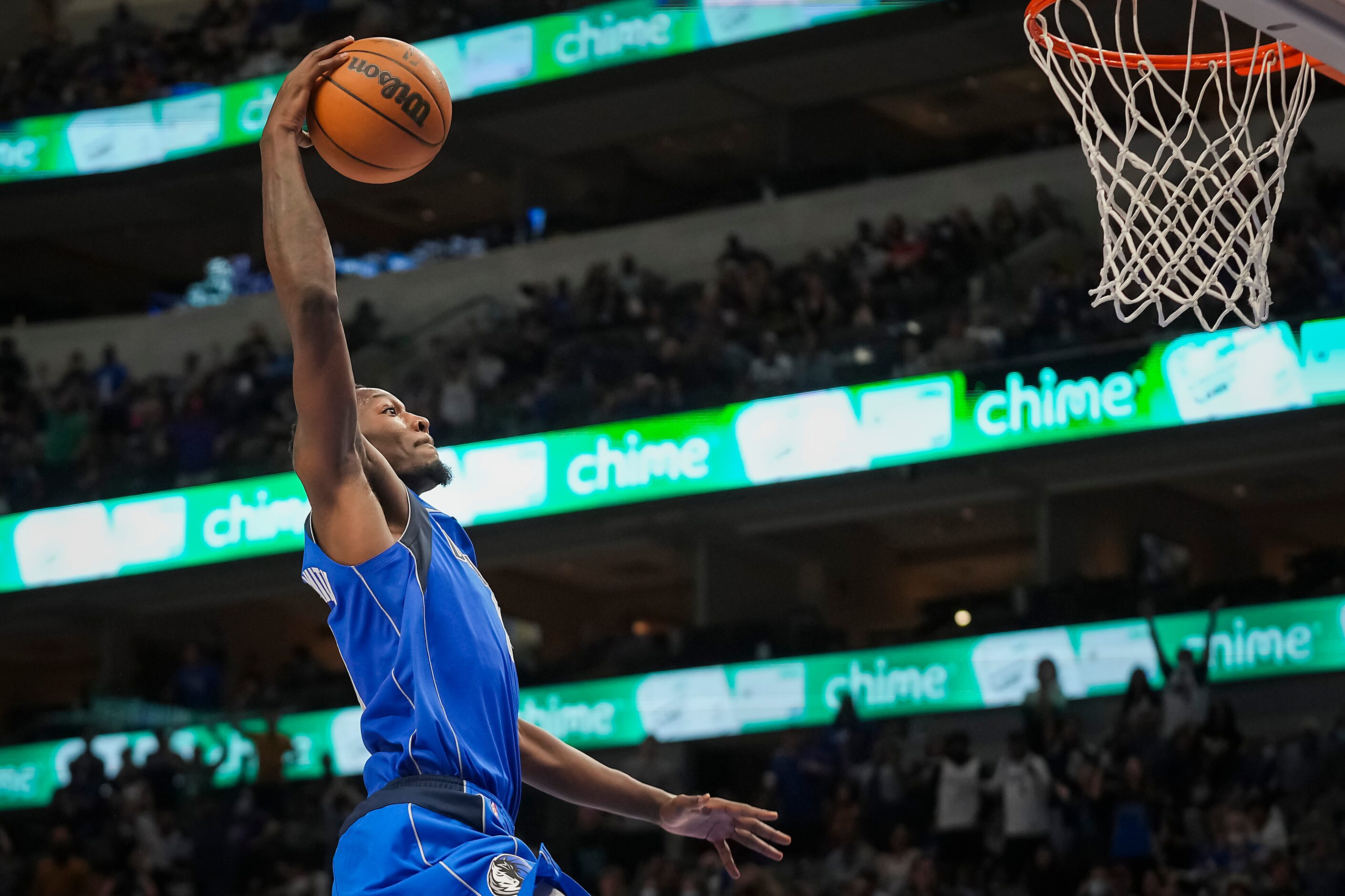 Dallas Mavericks forward Dorian Finney-Smith goes up for a break-away dunk during the second...