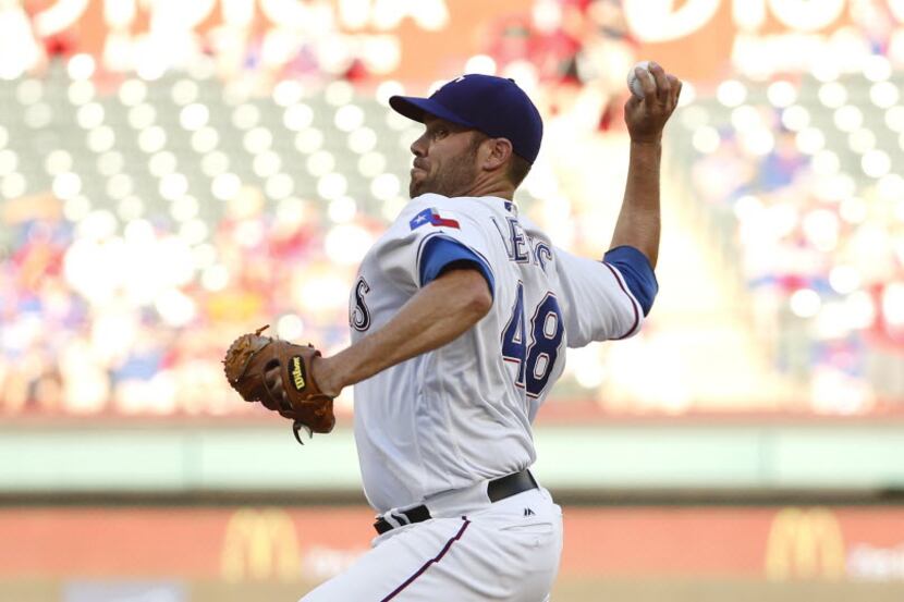 Texas Rangers starting pitcher Colby Lewis (48) throws against the Houston Astros in the...