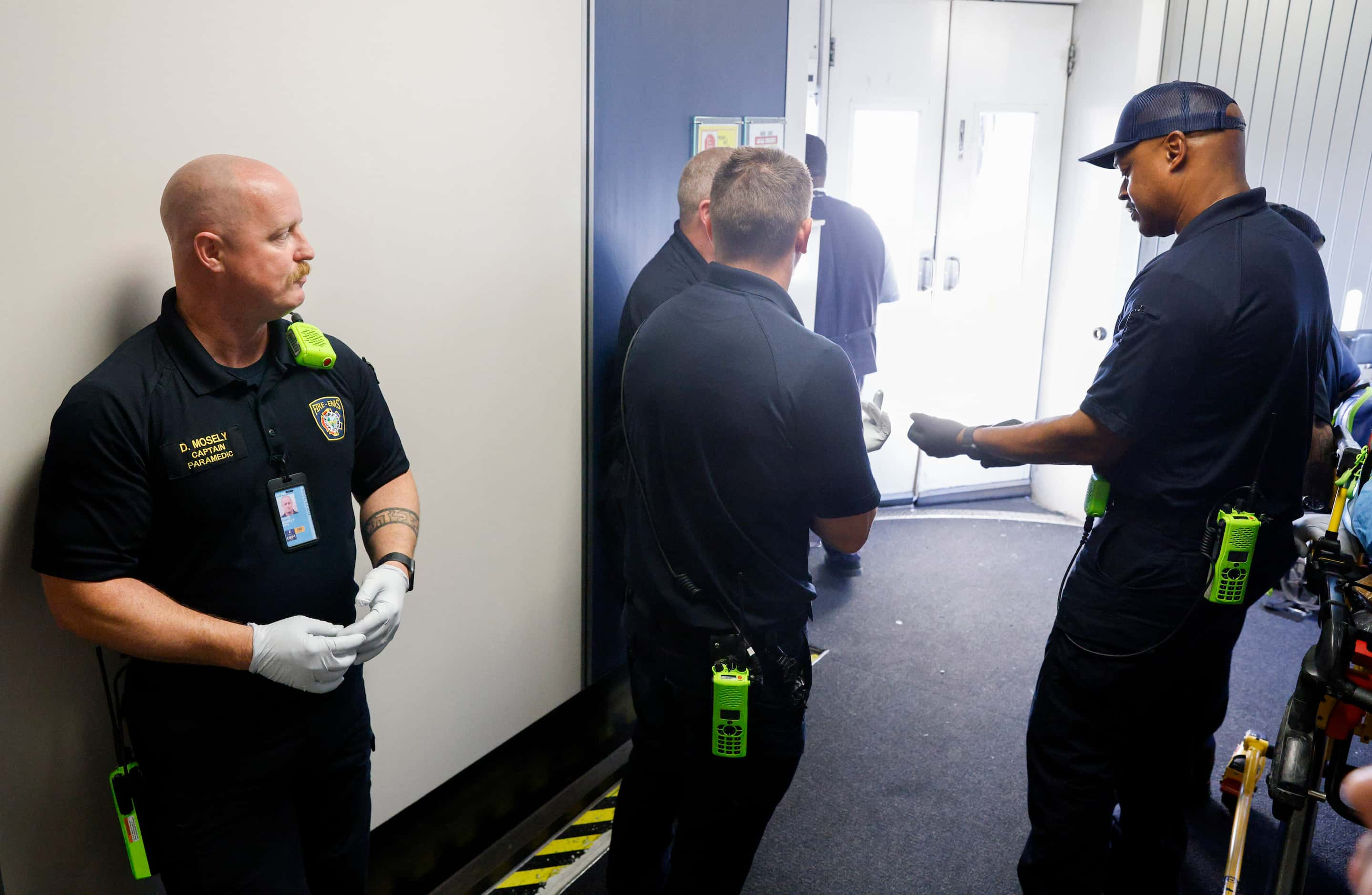 DFW Airport Fire Department captain David Mosely waits with other firefighters and...