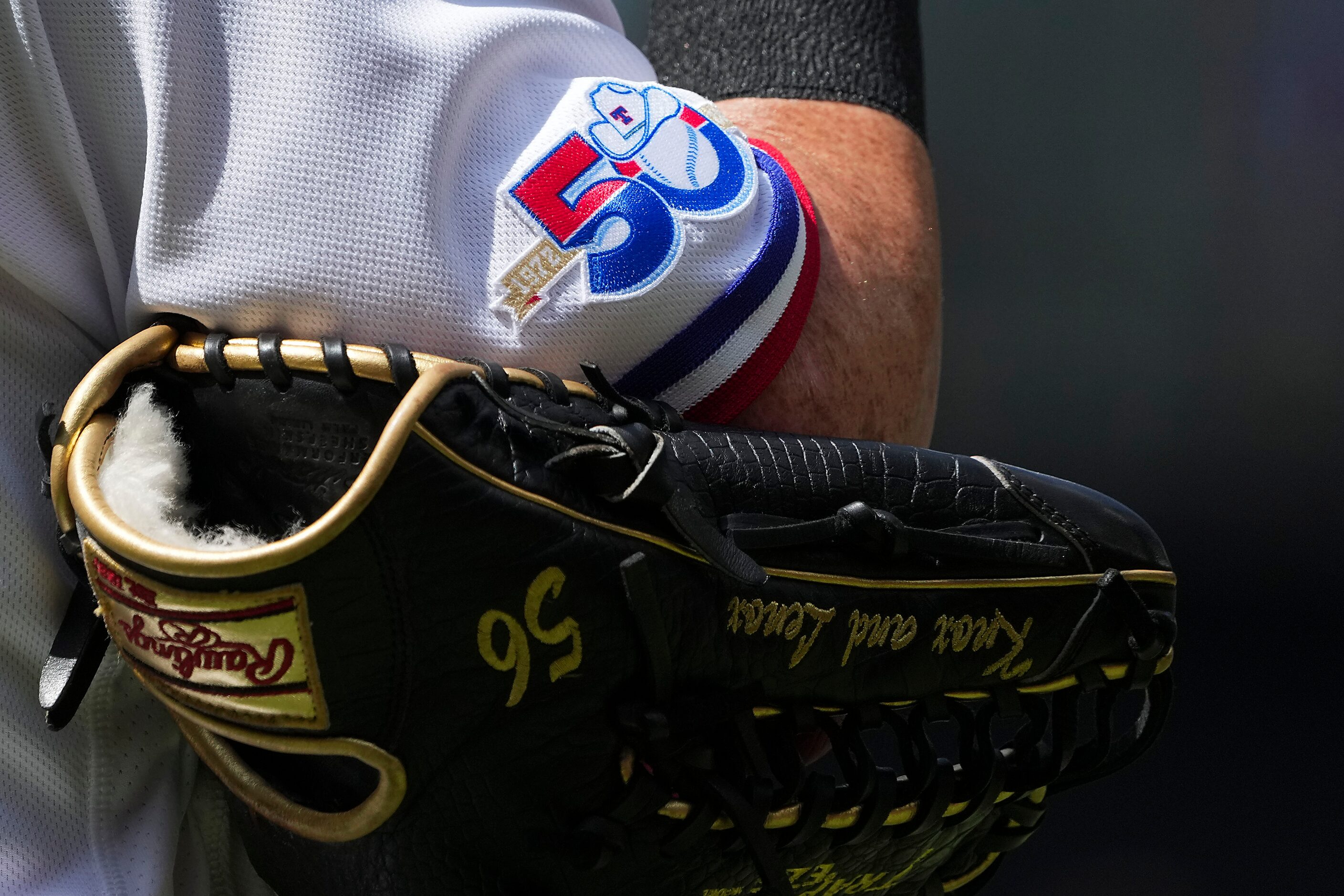 A patch commemorating the team’s 50 years in Texas is seen on the sleeve of Texas Rangers...