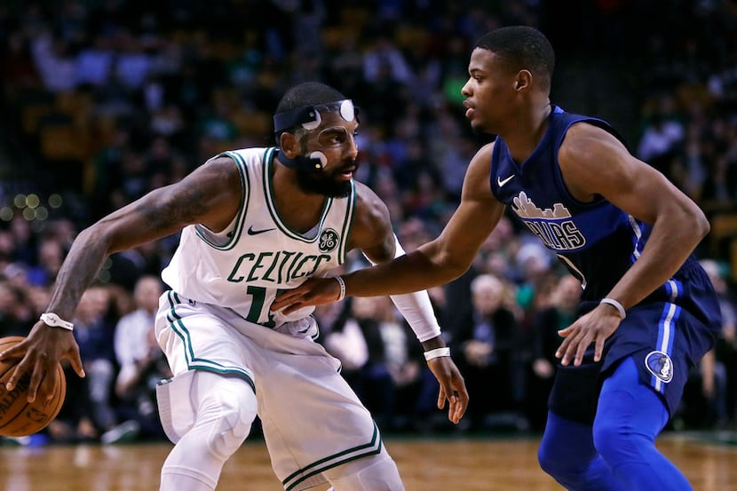 Boston Celtics guard Kyrie Irving, drives to the basket against Dallas Mavericks guard...