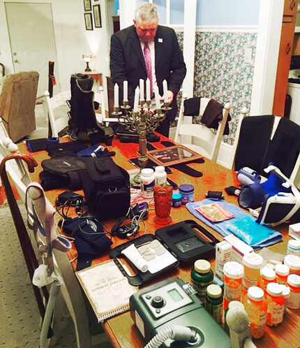 The dining room table in Ken Adams' Frankston, Texas, home is filled with medical supplies...
