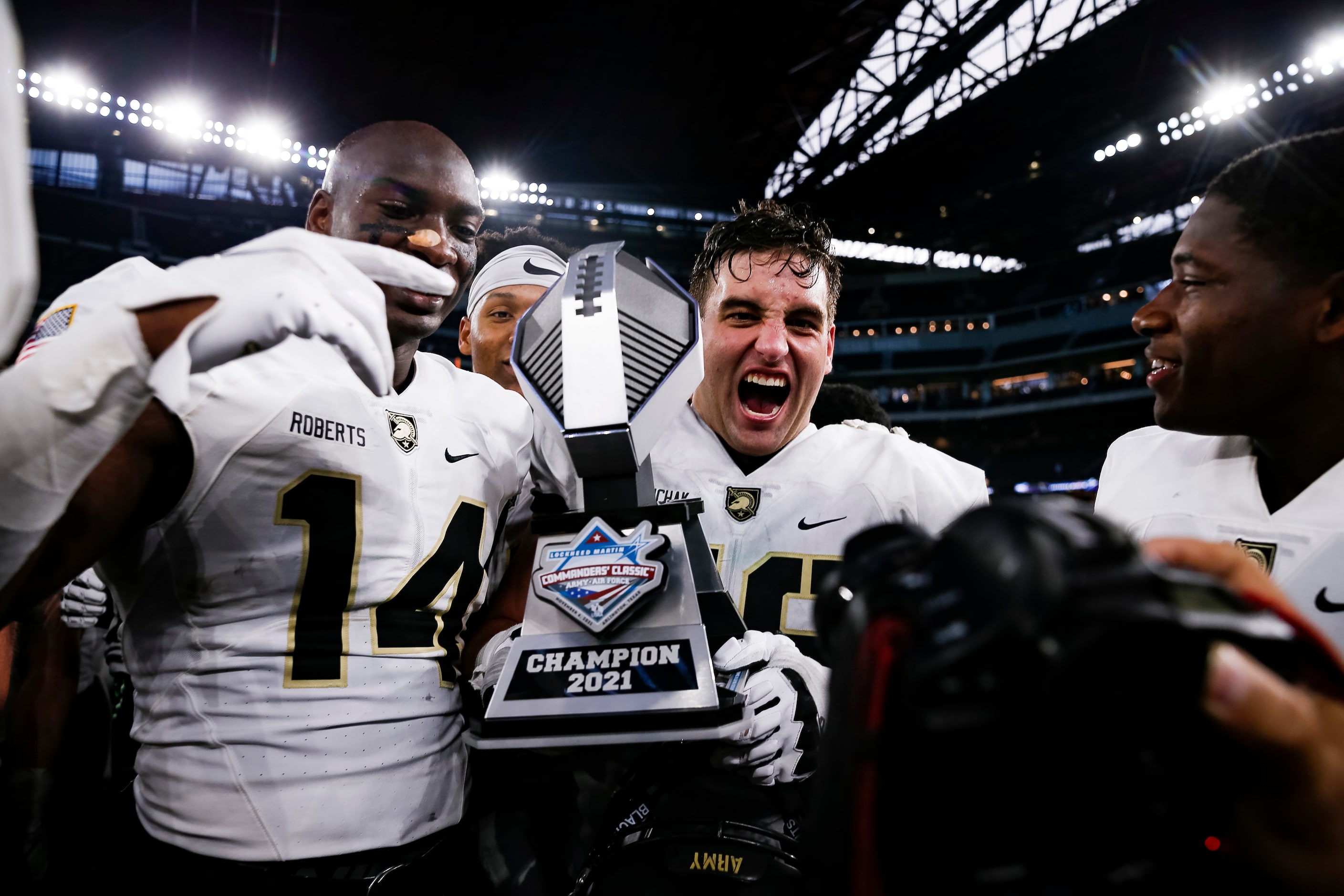 Army Black Knights hold the trophy after winning during overtime of the 2021 Lockheed Martin...