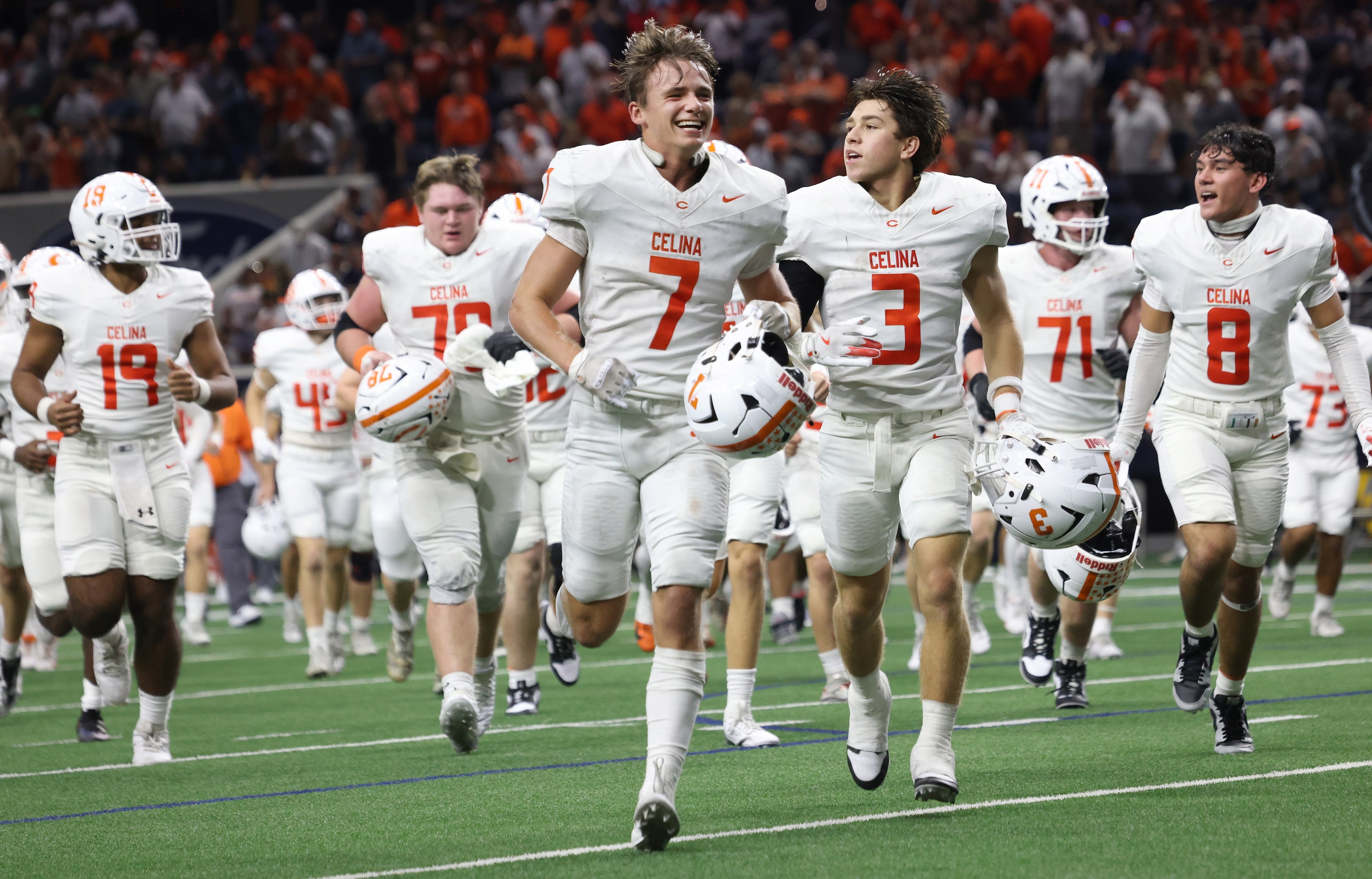 Celina players, led by Harrison Williams (7), and Logan Gutierrez (3), race toward the...