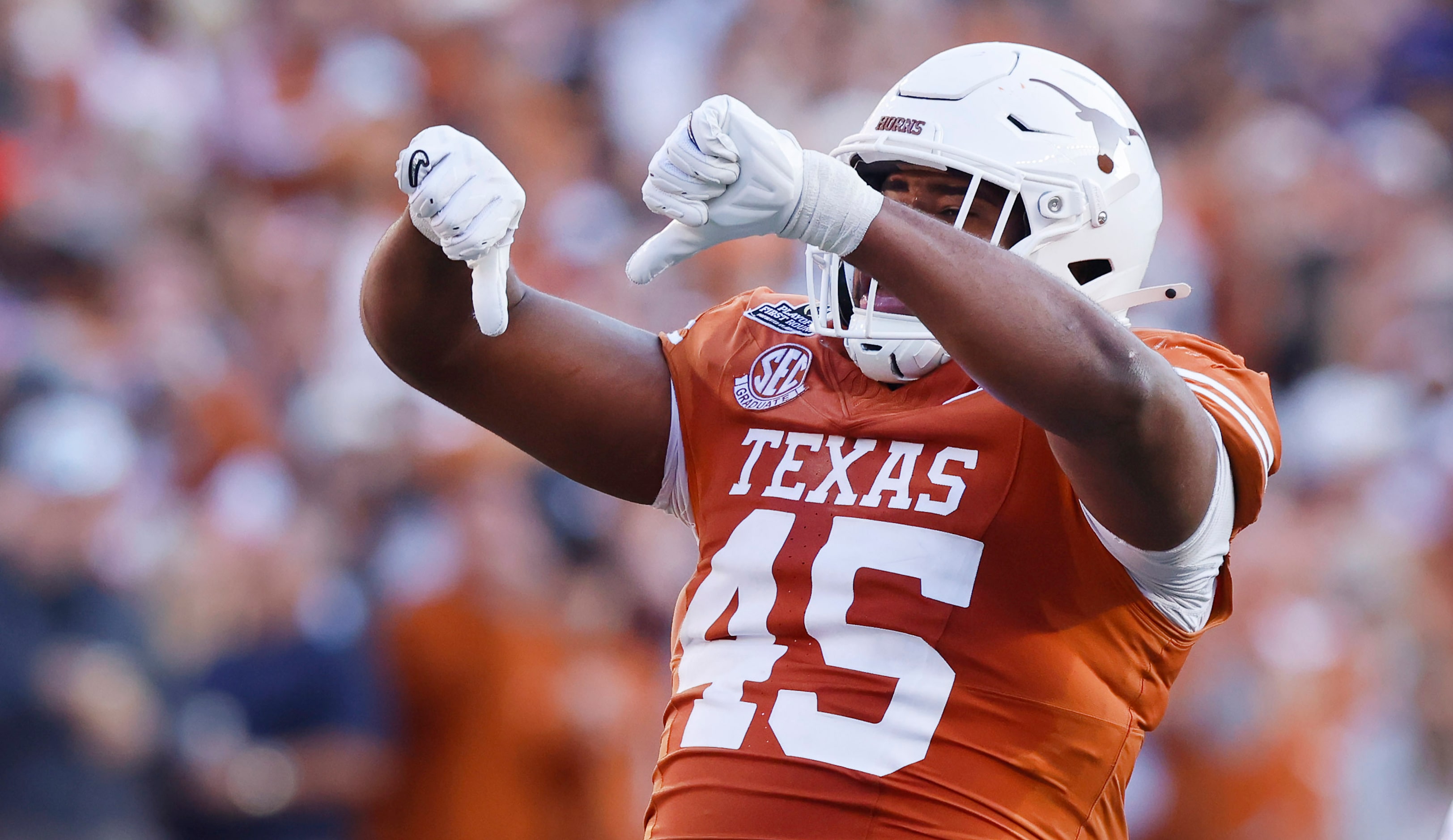 Texas Longhorns defensive lineman Vernon Broughton (45) gives a thumbs down after knocking...