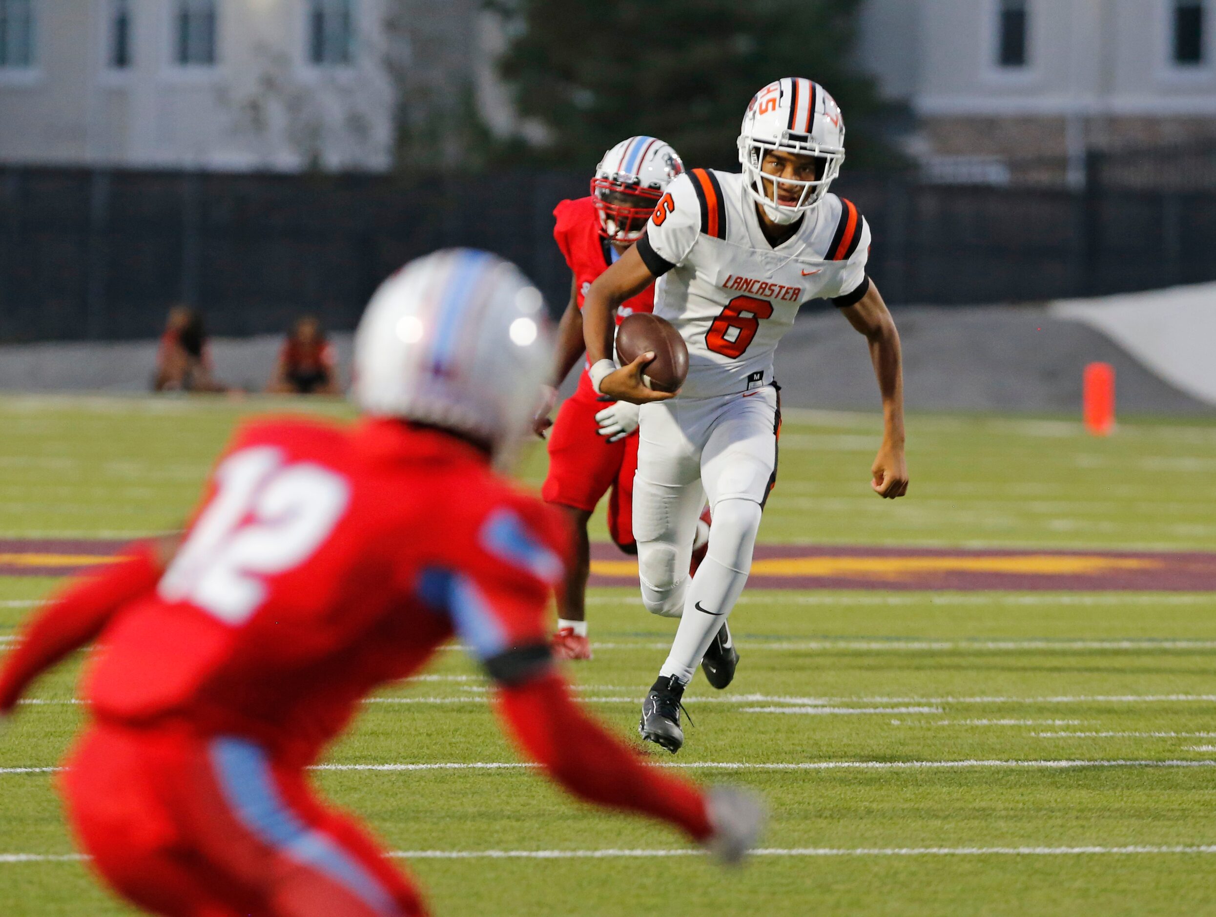 Lancaster High QB Carter Jones (6) scrambles during the first half of a high school football...