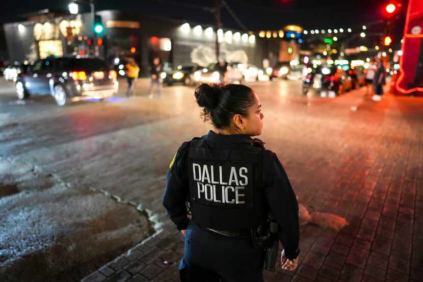 Dallas police Officer Irma Jaquez looks out on the intersection of Main Street at Malcolm X...