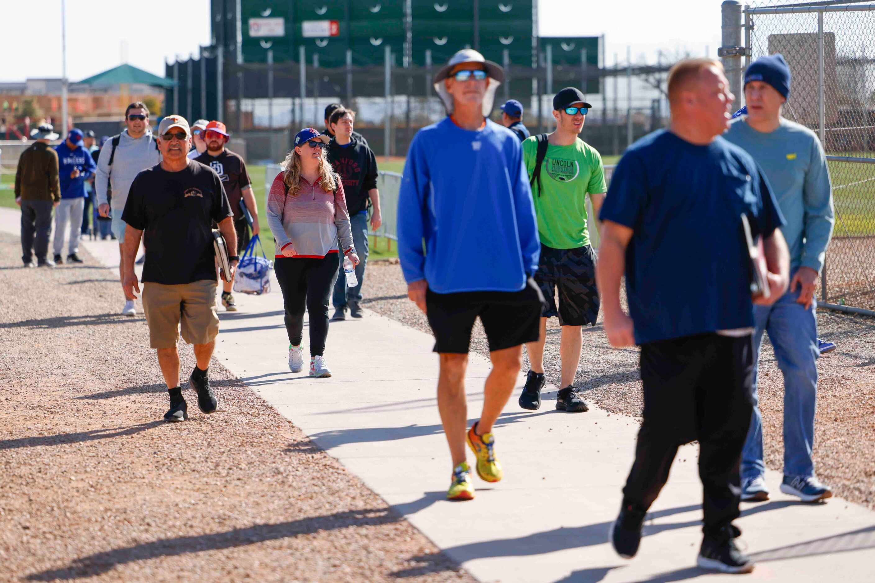 Fans make their way to Texas Rangers spring training on Saturday, Feb. 18, 2023, in...