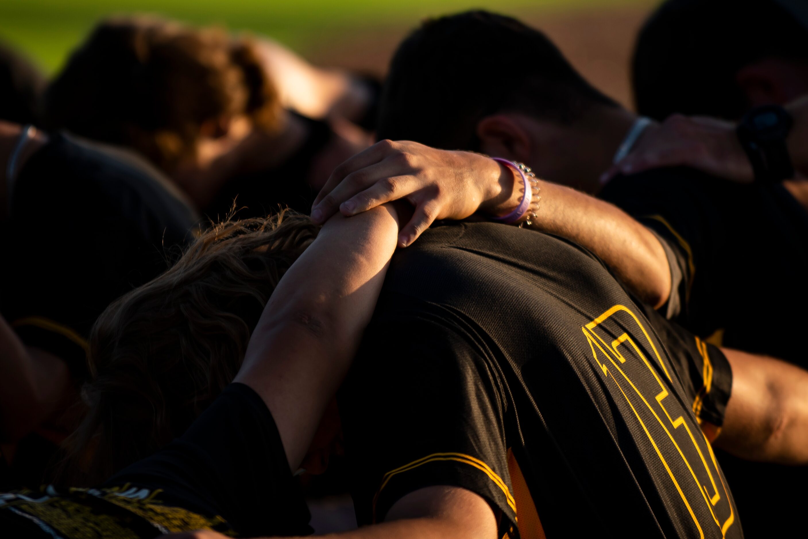 Forney players join hands during a prayer prior to the start of a baseball game between...