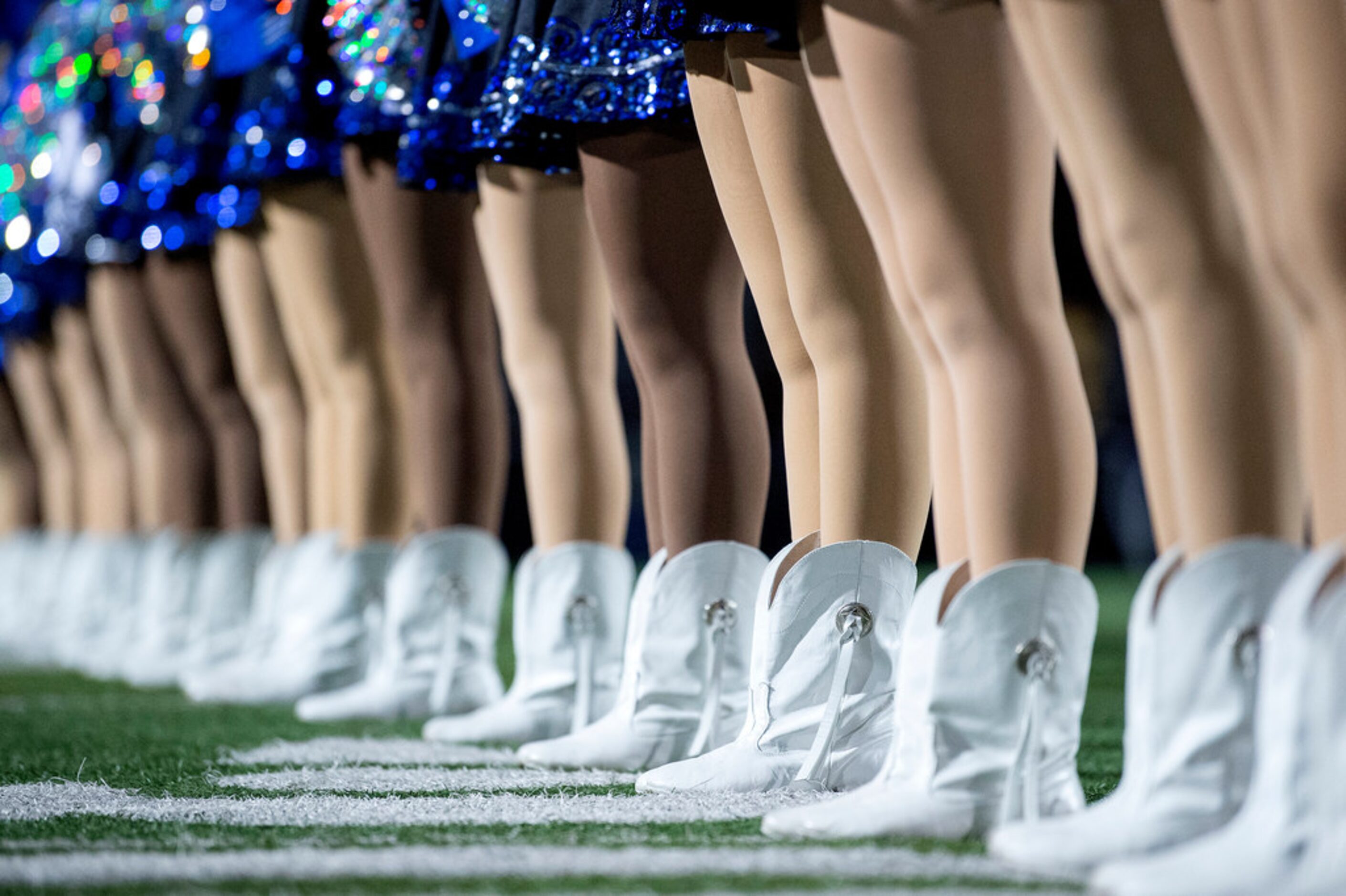 Hebron drill team members stand at attention before a high school football game against...