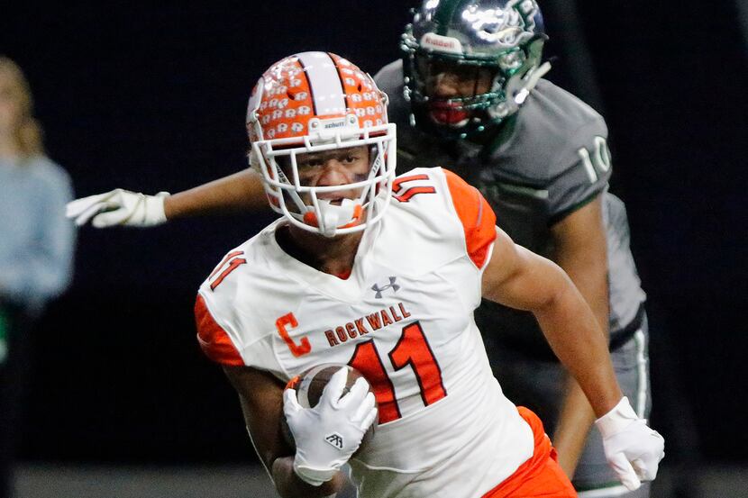 Rockwall High School wide receiver Jaxon Smith (11) scores a tochdown on this run after the...