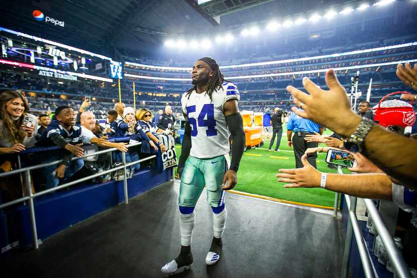 Dallas Cowboys middle linebacker Jaylon Smith is cheered by fans as he leaves the field...