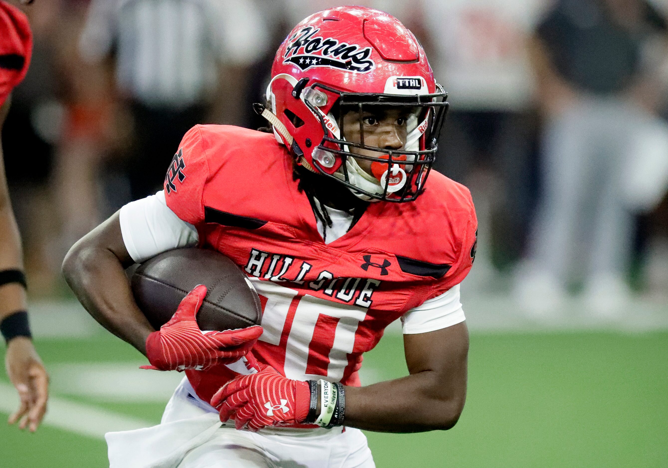 Cedar Hill High School running back Cededrick Castleberry (20) looks for room to run during...