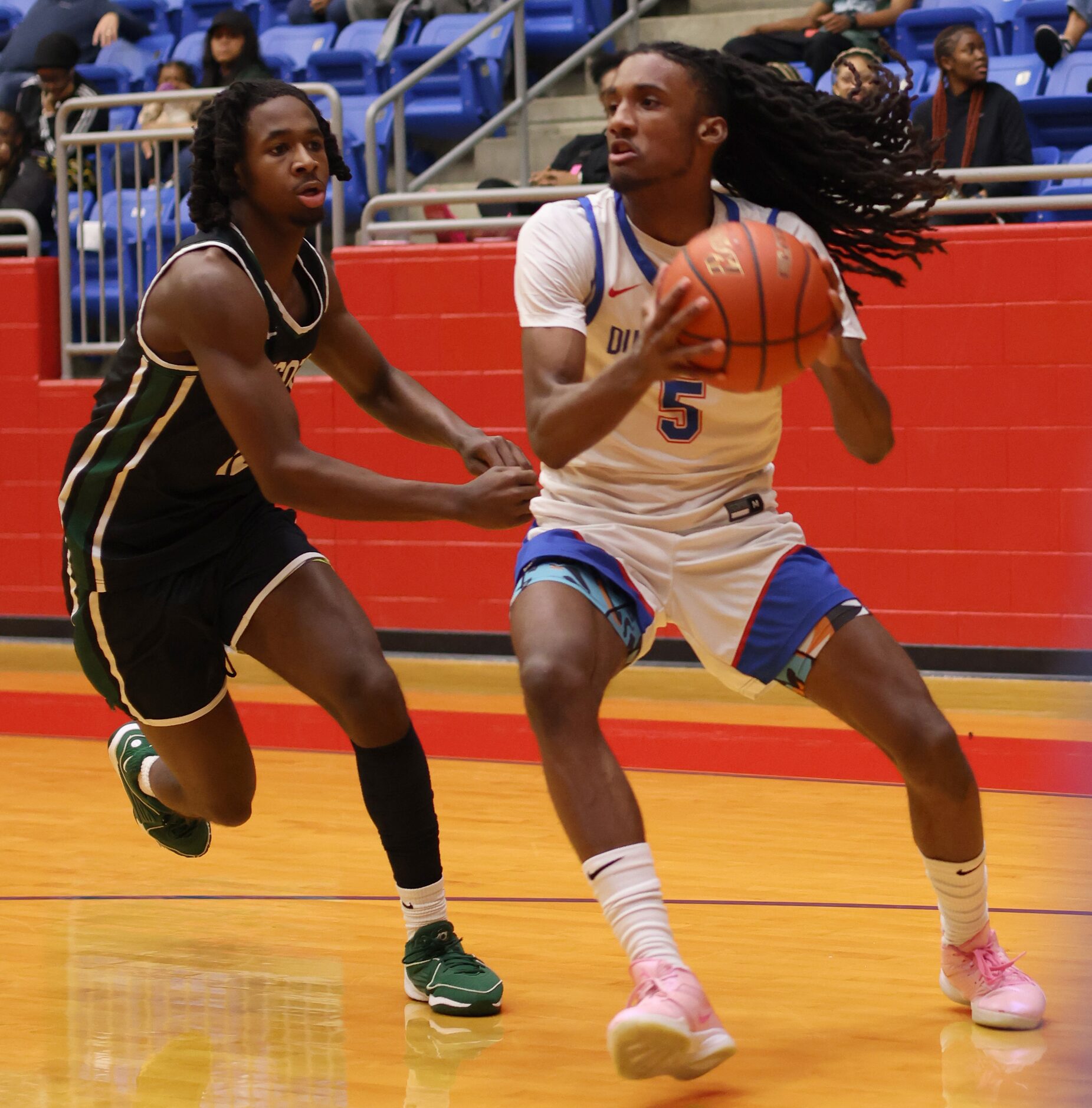 Duncanville guard Bugg Edwards (5) drives the baseline as DeSoto's Bryson Turner (12)...