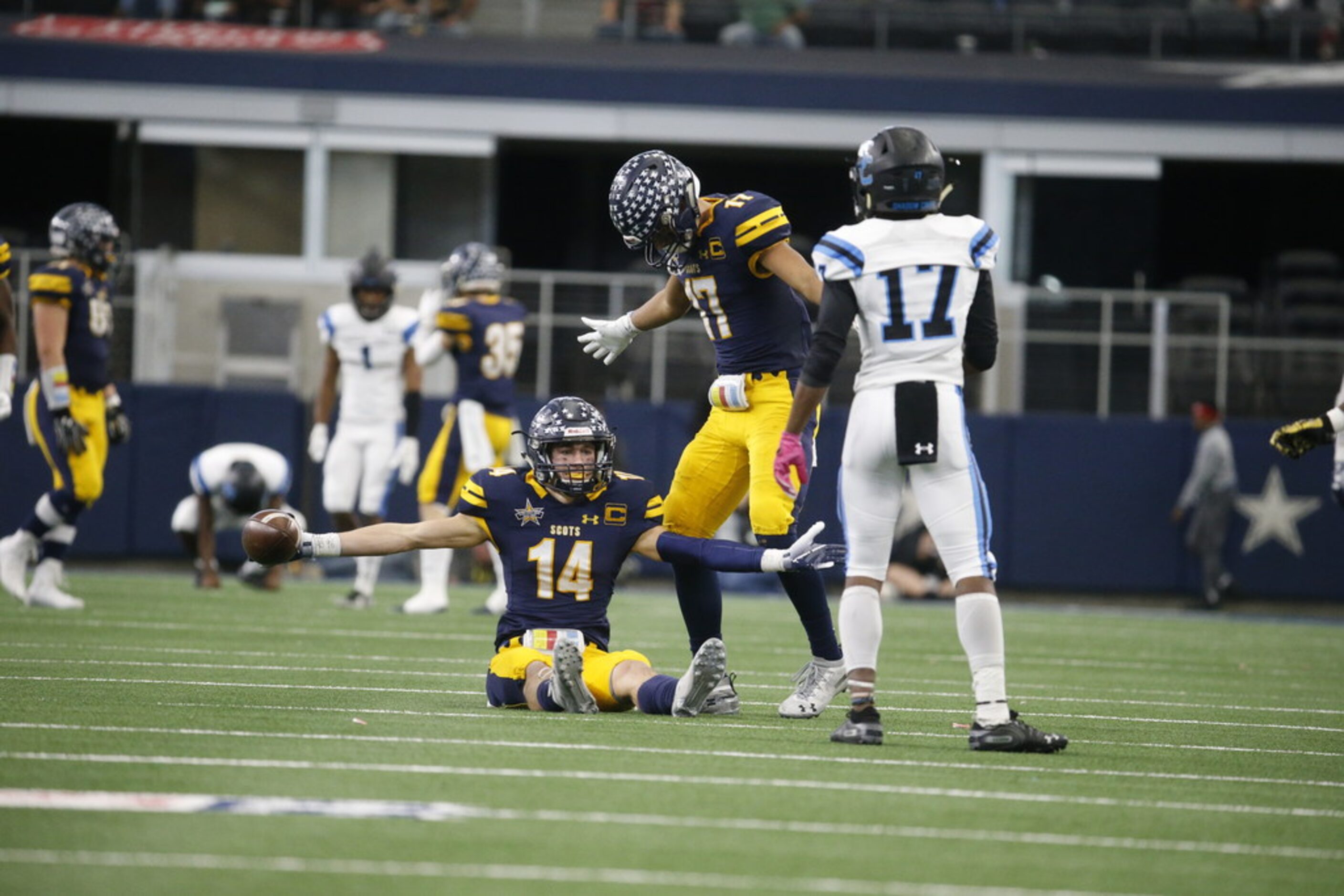 Highland Park's  Hudson Clark (14) celebrates an interception with Ryan Khetan (17) as...