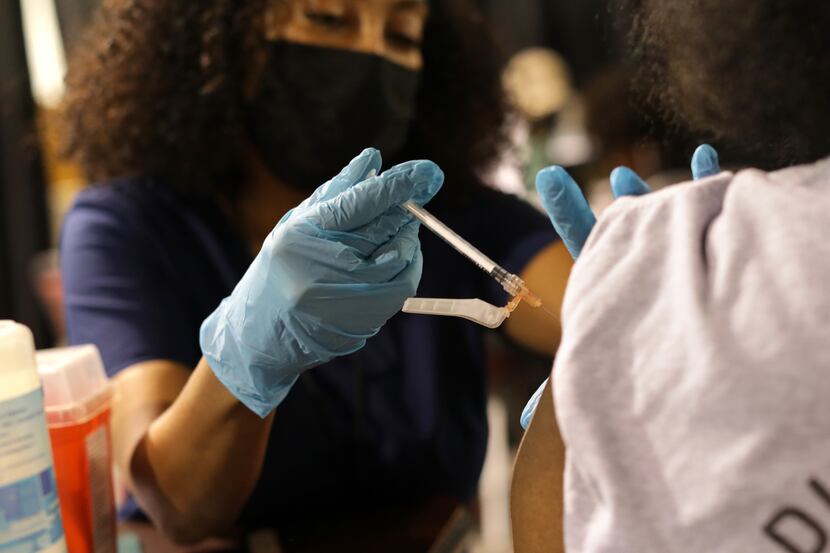 Mery Beyene administers the COVID-19 vaccine during a vaccination drive event at Mt. Rose...