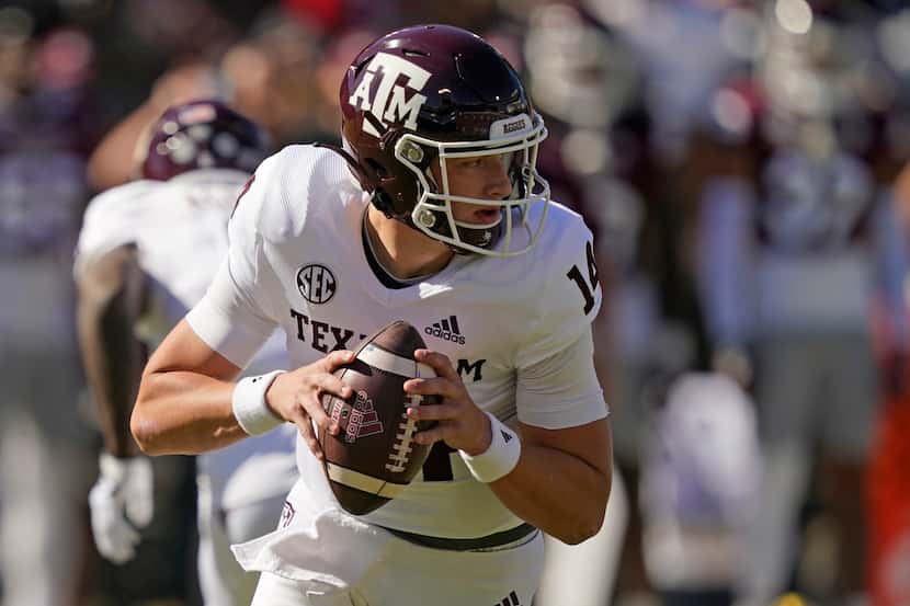 Texas A&M quarterback Max Johnson (14) looks for an open receiver during the first half of...