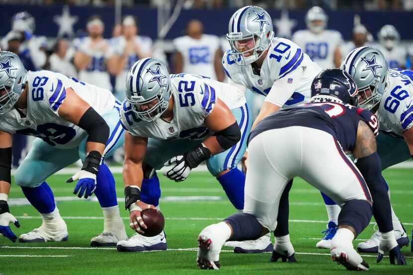 Dallas Cowboys quarterback Cooper Rush (10) takes a snap from center Connor Williams (52)...
