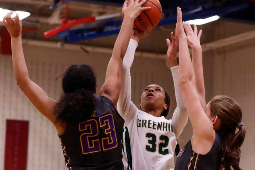 Greenhill's Kionce Woods (32) shoots a jump shot over the defense of Houston Kincaid...