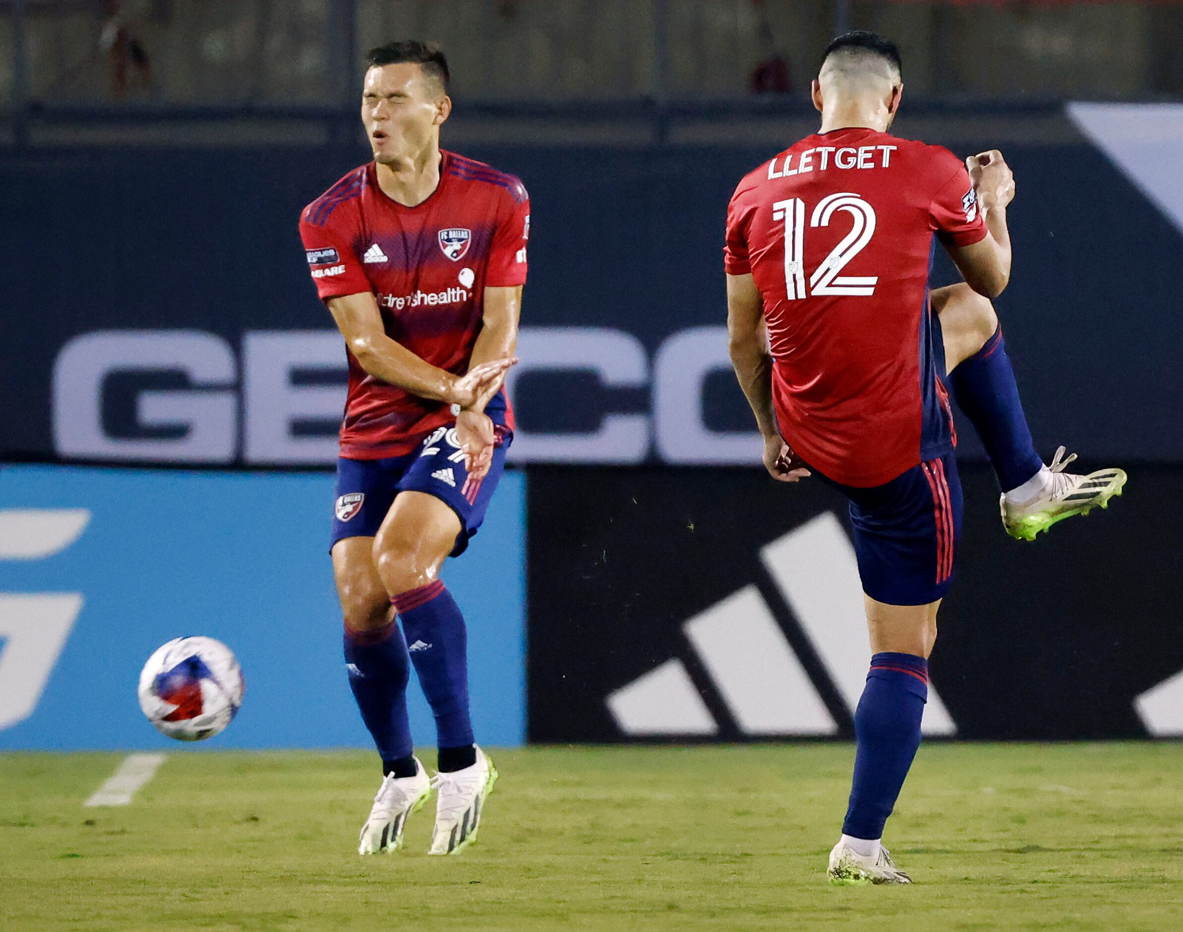 FC Dallas midfielder Sebastian Lletget (12) accidentally hits teammate Sam Junqua (29) when...