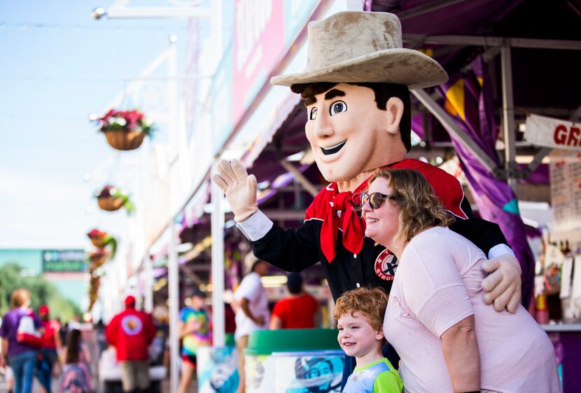 Simone and Max Garner pose with Little Big Tex on Oct. 4 at the State Fair of Texas. 
